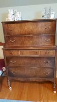 Full front view of dresser showing two upper drawers and two lower drawers with castors visible