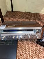 Front and side view of vintage Pioneer SX-3600 stereo receiver showing wood grain casing and metal front panel, placed on carpeted floor.