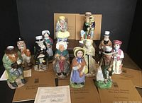 Collection of 12 hand-painted Charles Dickens Toby jugs with COAs and original boxes.