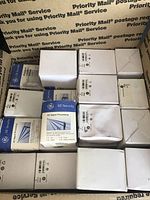 Top view of multiple white and blue GE Security boxes stacked closely together inside a shipping box, showing quantity and packaging.