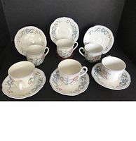 Image showing 6 sets of coffee cups and saucers with floral decorations on white porcelain