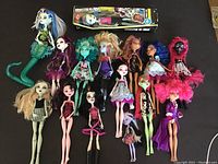 Full view of the 15 Monster High dolls including boxed doll and 14 loose dolls of various characters and conditions