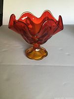 Front view of the vintage Viking amberina pedestal bowl showing ruffled top edge and gradient amber to red color