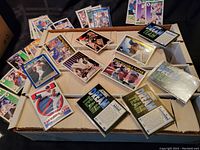 Two open boxes filled with assorted vintage baseball cards, top cards include Score Dream Team, Cy Young winners, and various players in protective sleeves.