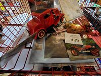 Red 1925 Model T Runabout car model with Certificate of Title and associated papers in a wire basket.