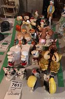Full lot of ceramic salt and pepper shakers showing various animal and figure shapes arranged on table.