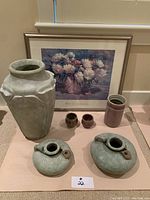 Overall shot of all items including large green vase with chip, small canteen vessels, small pots, pink cylindrical vase, and framed 'White Peonies' print.