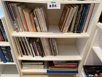 Books arranged on shelving unit with a mix of art, history, and calligraphy topics