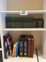 Photo showing top shelf with The Compact Edition Oxford English Dictionary volumes and other assorted books beside them.
