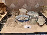 Clear glass kitchenware selection including bowls, measuring cups, baking dishes and serving items displayed on a countertop.