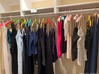 Hanging lingerie including nightgowns, camisoles and slips in various colors and fabrics such as black, white, teal, and navy blue