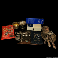 Overview of all items including serving pieces, napkin rings and assorted jewelry