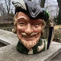 Front-facing close-up of Robin Hood character jug showing detailed facial features and glossy finish.