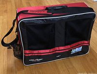 Front exterior of red and black Cat5Gear cyclist case showing mesh ventilation, piping, and branding patches.