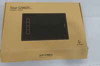 Closed box showing XP-Pen Star G960S Plus drawing tablet packaging with product image and branding.