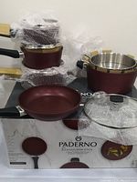 Maroon Paderno cookware set arranged on original box with bubble wrap