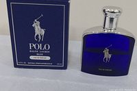Bottle of Polo Ralph Lauren Blue Eau de Parfum with original box beside it on a white surface.