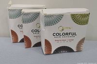 Three closed boxes of Gotog Colorful Hair Catcher in different colors, showing front and top sides of packaging.