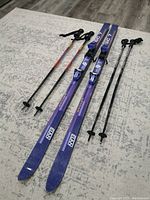 Pair of Elan SC 7 skis with two pairs of ski poles.