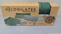 Front of Logilates Premium Fit Kit box showing kit contents including yoga mat, yoga block, foam roller, towel, and scrunchies