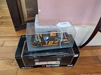 Two diecast cars, NASCAR stock car and Dodge Viper, shown together with packaging.