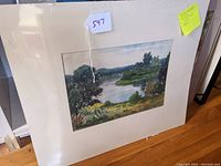 Front view of the matted watercolor landscape painting showing river and foliage.