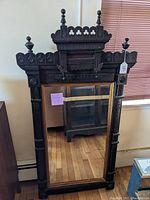 Full front view of mirror and frame showing overall design and condition