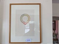 Framed full view of the watercolor painting showing the circular form and the matting, with reflections in the glass.