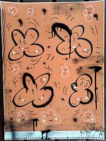 Close-up photo of the painting showing detail of abstract smiley faces and black outlined shapes on burnt orange background with artist signature bottom right