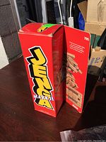 Boxed Jenga Mark II game showing front and side with bold yellow logo on red box.