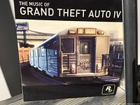 Front cover of GTA 4 soundtrack CD showing subway train with Rockstar logo.
