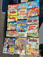 Flat laying collection of Archie and Jughead comics and magazines showing variety of titles and colorful covers.
