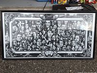 Framed black and white collage of faces titled 'The Jam: Part 1 - The History' with artist signature, showing artistic detail and frame.
