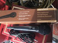 Photo of boxed Genaxa dynamic microphone and unboxed microphone with cables.
