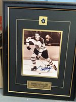 Front view of framed signed Frank Mahovolich hockey portrait, showing signature, team logo, and plaque.