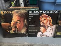Two Kenny Rogers LP vinyl record covers, including 'Greatest Hits' featuring portraits of him.