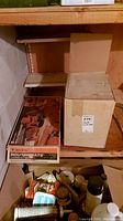 Shelf with two boxes, one labeled Black & Decker Routemate Workmate, the other a plain box.