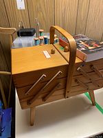 Photo of the wood fold-out sewing box showing the exterior and handle on top