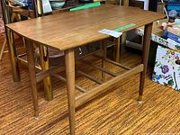 Full view of wooden side table showing rectangular top and lower rack.