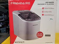 Photo of boxed Frigidaire silver ice maker with product specifications on box.