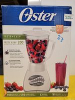 Oster Fresh and Easy Precise Blend 200 blender box front showing product image, brand name, features such as 700 peak watts, 450 blending watts, 12 speeds, 6-cup glass pitcher, and crush pro 4-blade system.