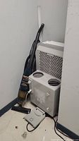 Portable air conditioner and vacuum placed side by side