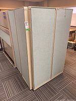 Side view of cubicle divider panels folded to form corner setup.