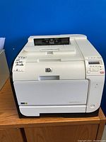 Front view of printer showing housing and paper output area