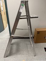 Side view of the aluminum A-frame step ladder showing the structure and platform.