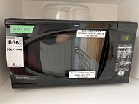 Front view of the black Danby Designer microwave with windowed door and control panel. Identifying stickers visible.
