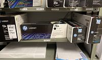 Shelf of HP toner cartridges 13A, 78A, and 58A boxes with model numbers and labels visible