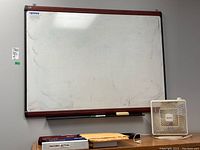 Photo showing the Quartet white board with visible marks and a white Duracraft box fan on a surface below it.