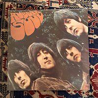 Front cover of The Beatles Rubber Soul vinyl LP showing band members and title logo.