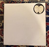 Front album cover of The Beatles White Album with white background and embossed text, showing limited edition sticker